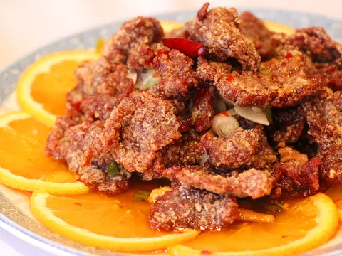 Crispy fried dish served over orange slices at Peking Duck House