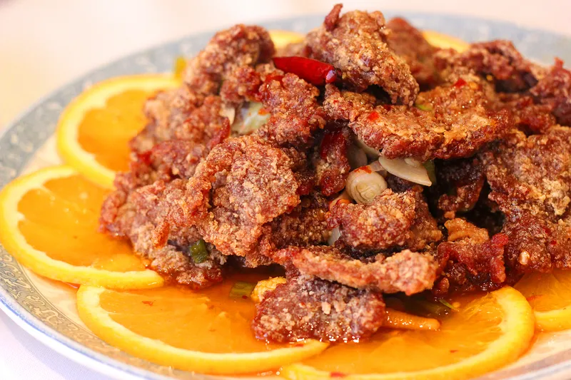 Crispy fried dish served over orange slices at Peking Duck House