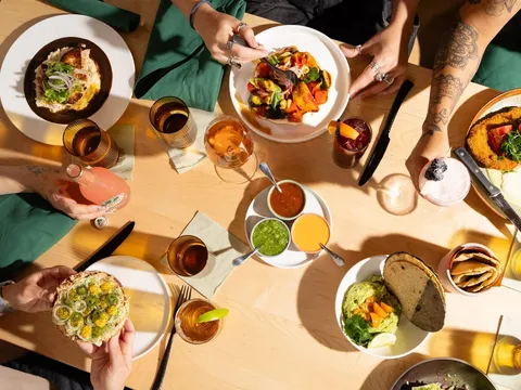 A table spread of tacos, tostadas, salsas and drinks at Maíz de la Vida