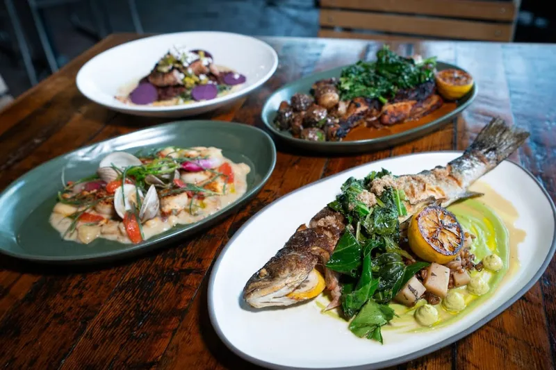 Seared fish, scallop and clam pasta, and roasted chicken plates at Rhubarb