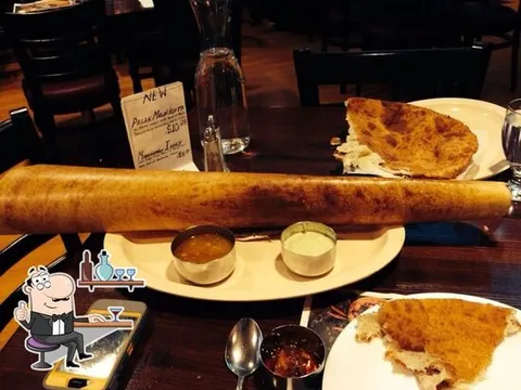 Dining room table with a long dosa at Udupi Palace in Chicago.