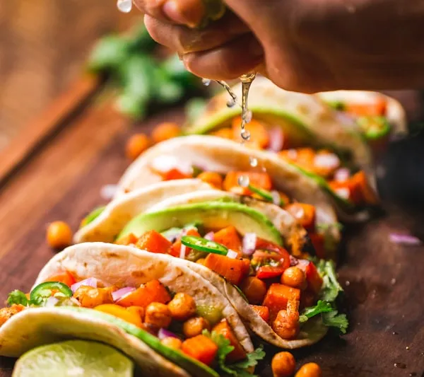 Charred broccoli tacos served with pickled onions and fresh cilantro on handmade tortillas at Tacos Oscar