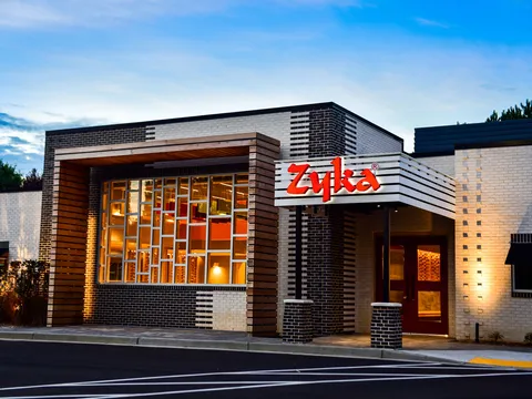 Zyka: The Taste storefront at dusk with the illuminated red Zyka sign over the entrance in Decatur, Georgia