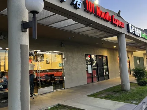 Storefront of 101 Noodle Express in Alhambra, with neon signage