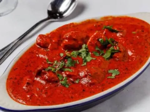 Butter chicken in tomato-butter methi sauce garnished with cilantro at Nirvana Indian Cuisine in New Orleans