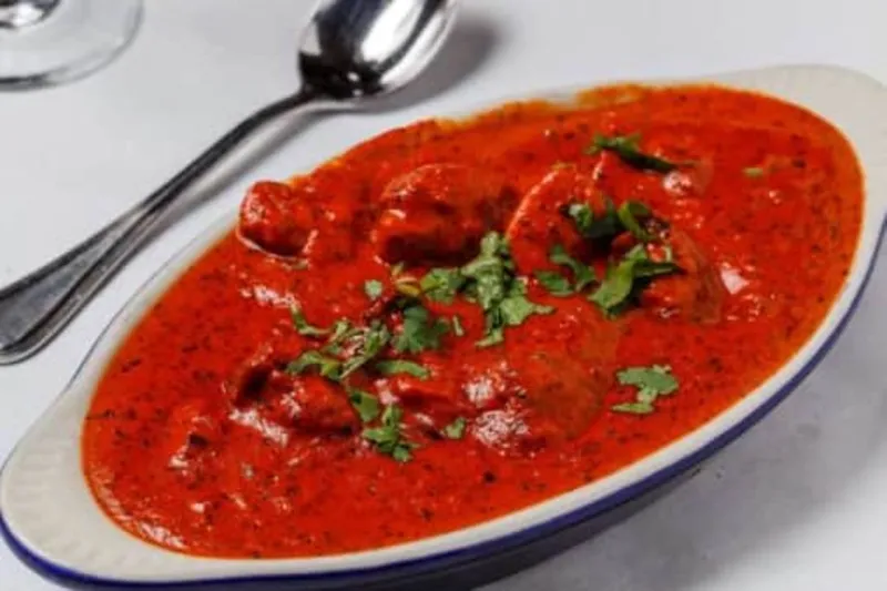 Butter chicken in tomato-butter methi sauce garnished with cilantro at Nirvana Indian Cuisine in New Orleans