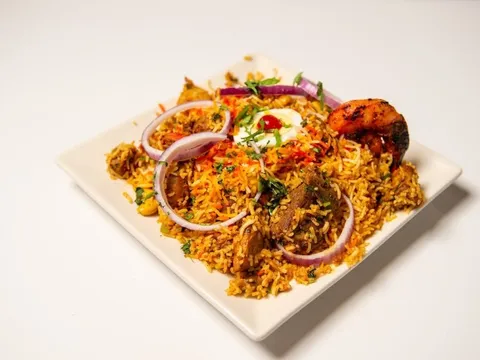 Plate of biryani with garnishes at Rasoi