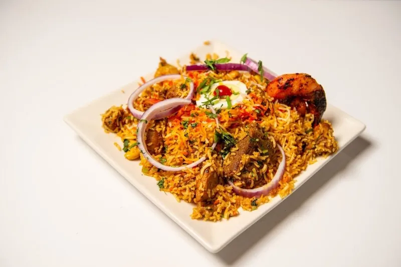 Plate of biryani with garnishes at Rasoi