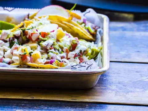 Tray of street tacos with pico de gallo, crema, radish and lime at Midtown's Cantina Alley