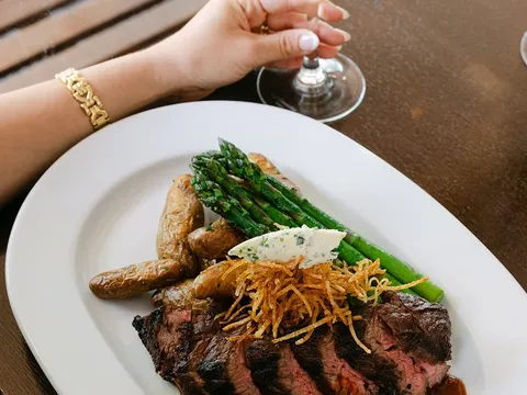Sliced steak with roasted potatoes and asparagus at The Corner Kitchen
