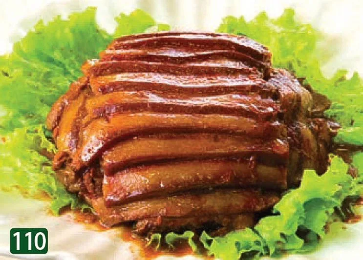 Braised sliced pork belly glazed in dark sauce, fanned over green lettuce, a Cantonese dish served at Star Kitchen in Denver