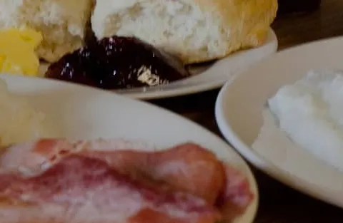 Breakfast plates of grits, eggs, bacon and biscuits at Mother's Restaurant