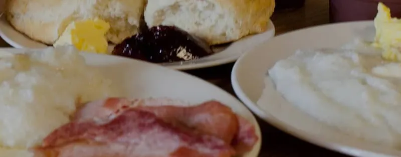 Breakfast plates of grits, eggs, bacon and biscuits at Mother's Restaurant
