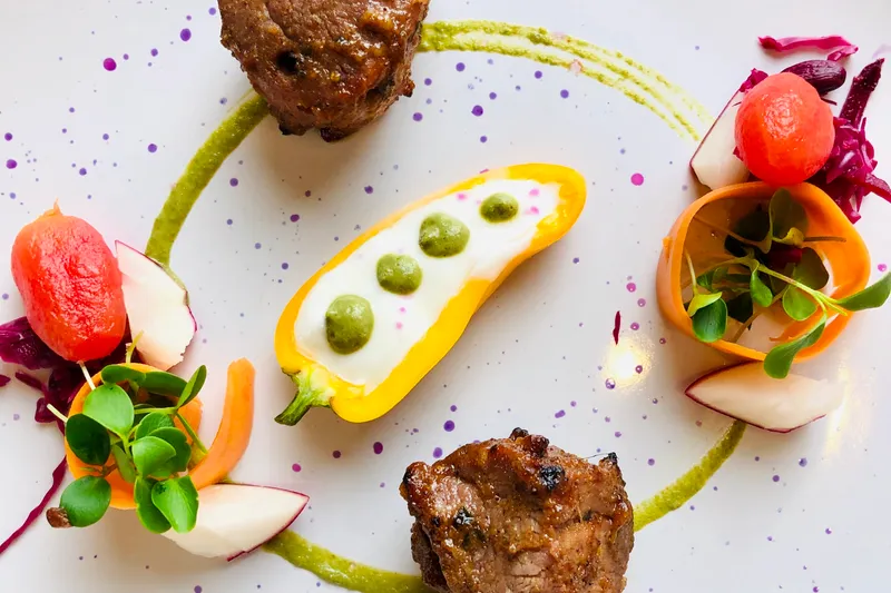 Plated grilled lamb kebab with microgreens, pickled radish and watermelon at Coromandel Cuisine of India, Darien