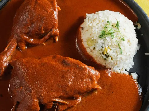 Plate of mole negro with chicken and rice at Guelaguetza