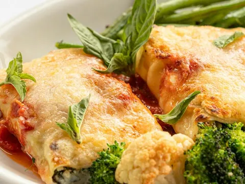 Baked manicotti with melted cheese, tomato sauce, broccoli, cauliflower and basil at Lidia's Kansas City.