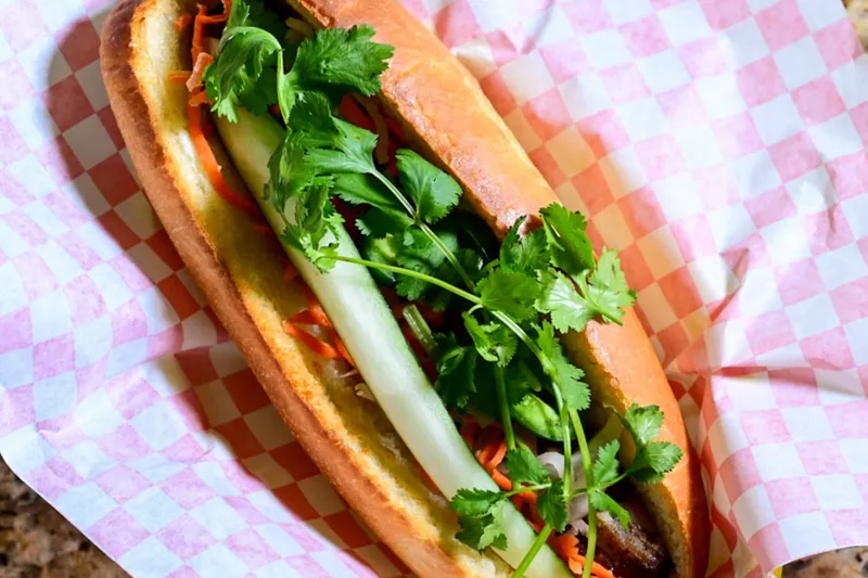 Bánh mì sandwich with pork, pickled carrots and cilantro on a paper-lined tray at Da Vang Restaurant in Phoenix