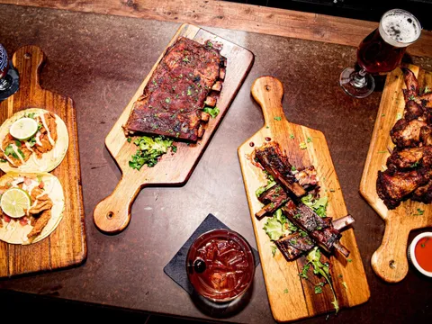 Overhead spread of ribs, wings, tacos and cocktails at Hammerheads