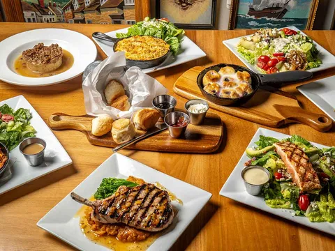 Steaks, salads and sides spread across a table at Crazy Cat Eat Up