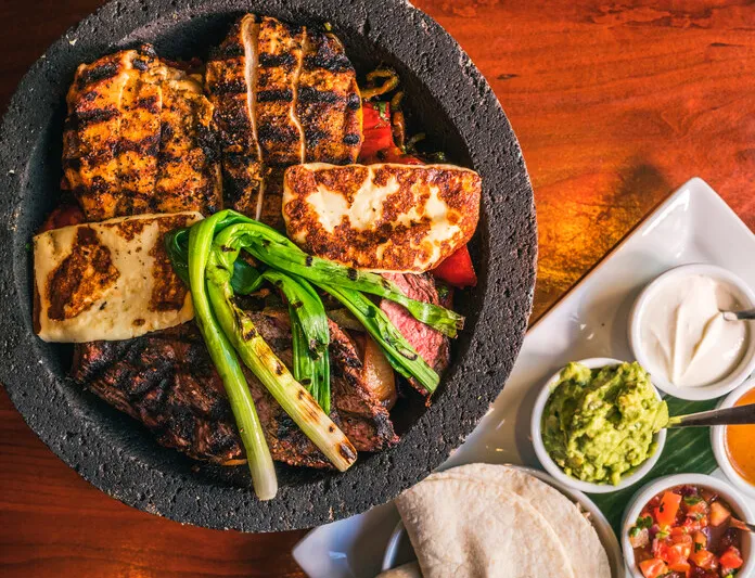 Grilled meats and vegetables with tortillas and salsas at El Vez Philadelphia