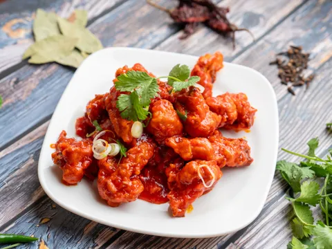A plate of sauced vegetable appetizer from Woodlands Indian Vegetarian Cuisine.