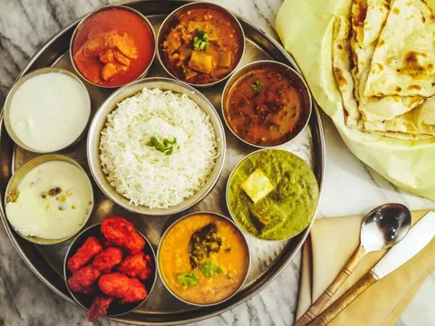 Indian thali with basmati rice, assorted curries, palak paneer and naan at Tabla Indian Restaurant