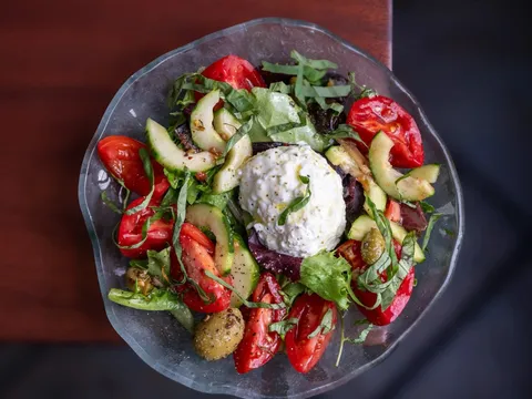 Tomato and burrata salad plated at Bittersweet Bistro
