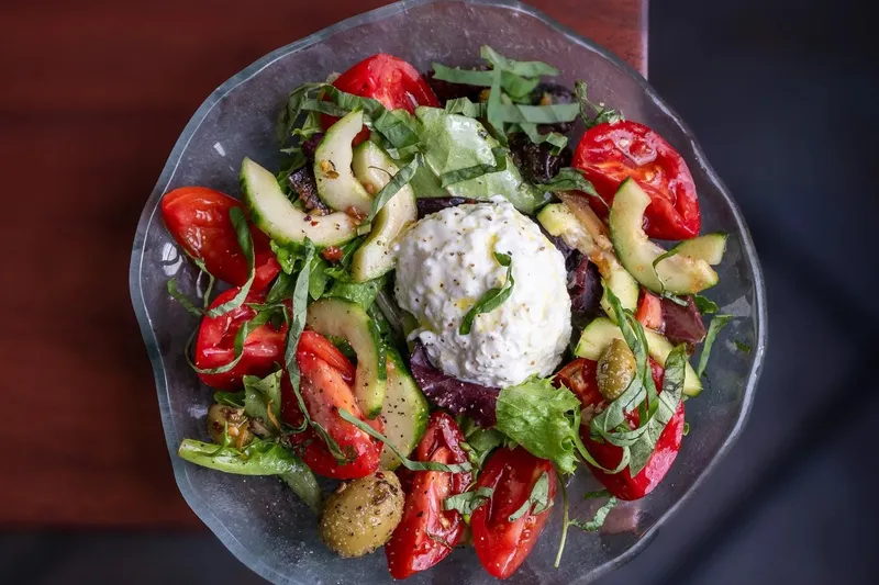 Tomato and burrata salad plated at Bittersweet Bistro