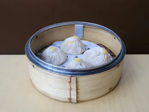 Bamboo steamer of soup dumplings (xiao long bao) at Birds of a Feather
