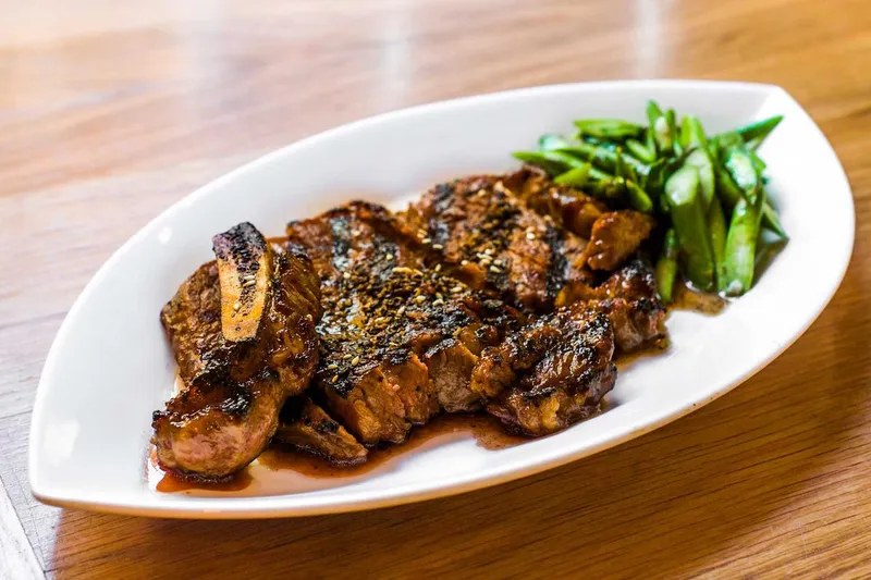 Grilled dish with scallions on an oval plate at RedFarm