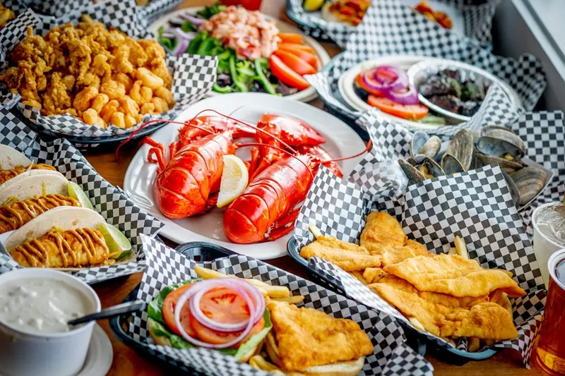 Spread of lobster, fried clams, fish and chips and seafood rolls at Newick's Lobster House