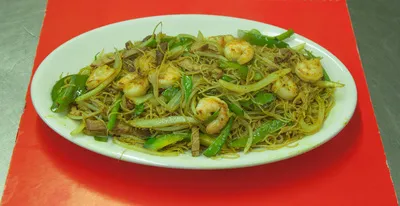 Shrimp with thin rice noodles and vegetables on a white platter at China Jade Chinese Restaurant in Cleveland