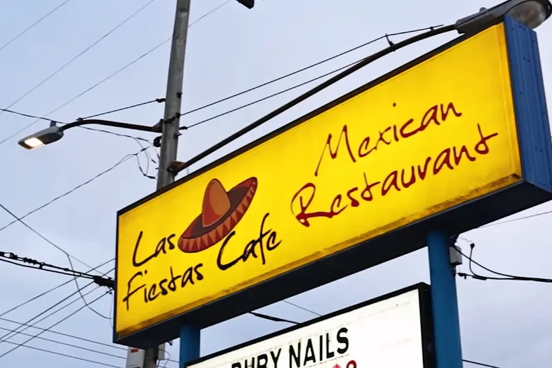 Yellow roadside sign for Las Fiestas Cafe Mexican Restaurant