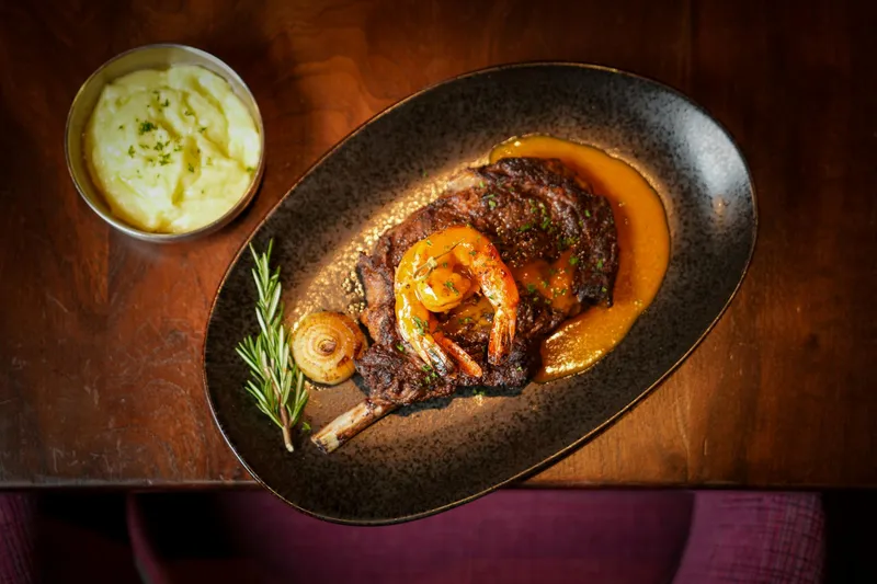 Limón rotisserie chicken plated with sauce and mashed potatoes