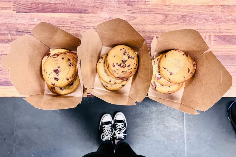 Three sandwiches served in takeout trays at Asa