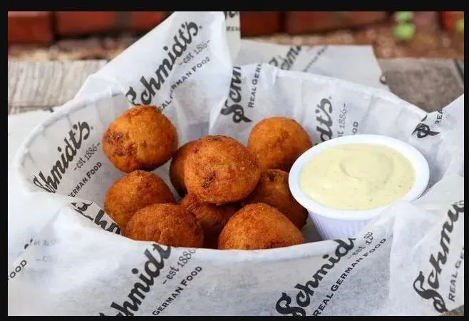 A basket of Schmidt’s fried sauerkraut bratwurst balls with creamy mustard sauce