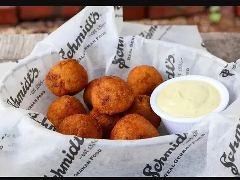 A basket of Schmidt’s fried sauerkraut bratwurst balls with creamy mustard sauce