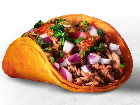 A single Teddy's Red Tacos beef birria taco on a red-tinted crispy corn tortilla topped with diced onion, cilantro and salsa
